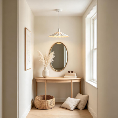 White ceramic pendant light with adjustable hanging cord over a dining table