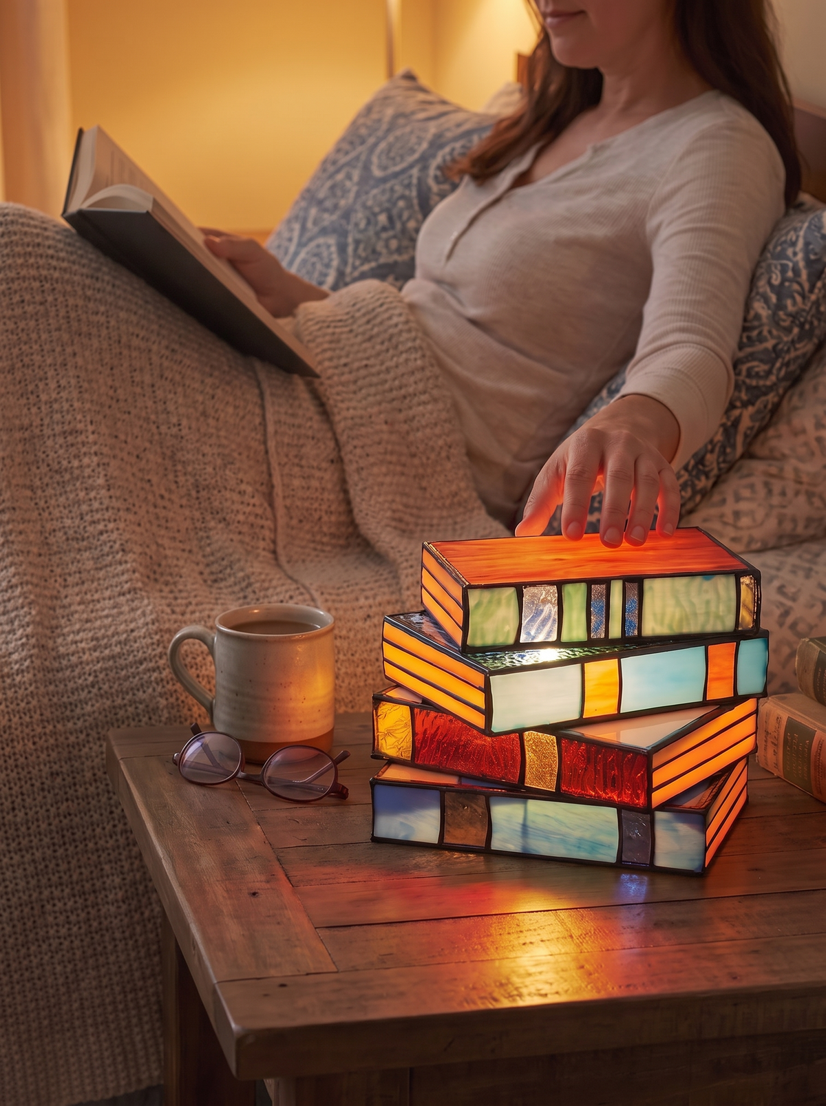 Stained glass book lamp on a shelf at home